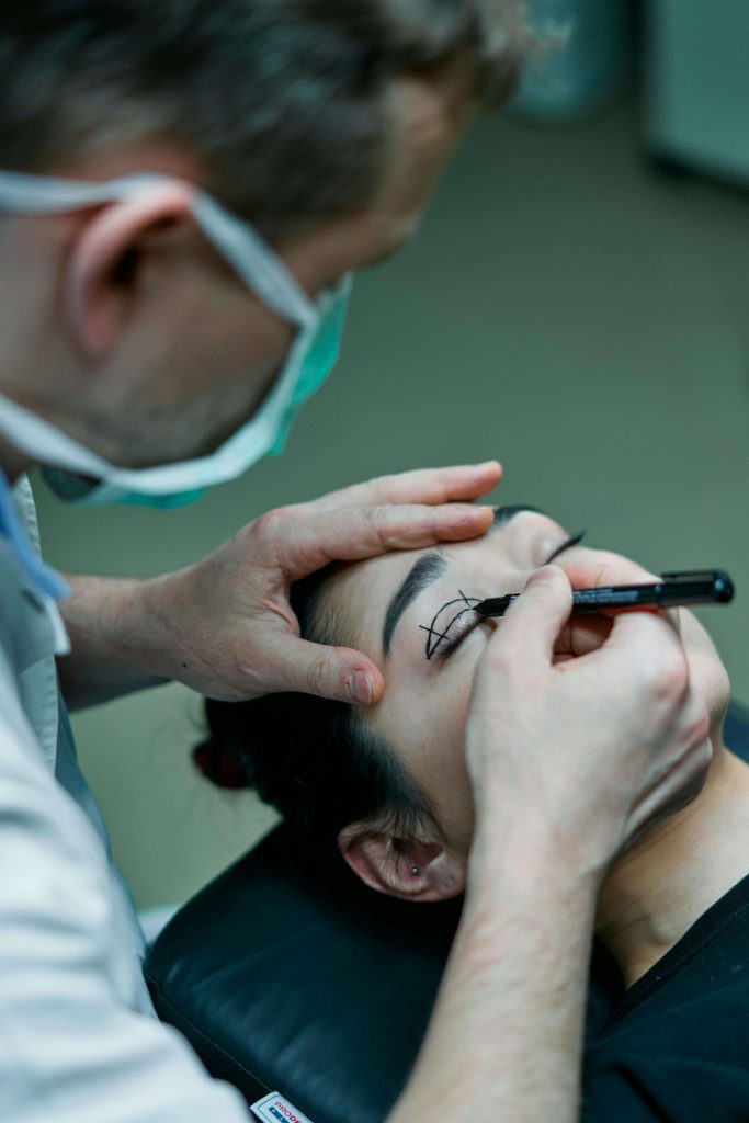 the doctor starts the eyelid surgery by carefully marking and measuring the eyelids of individual