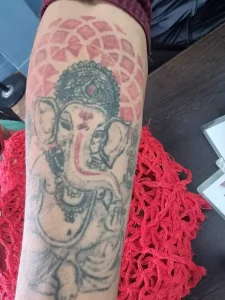 Sample 4 showing a complex, multi-colored tattoo with detailed artwork, highlighting the challenges involved in laser tattoo removal. The image emphasizes that due to the intricate design and multiple ink colors, the removal process requires advanced precision and expertise. The approximate cost of removal is around Rs. 15,000 when performed carefully by an experienced dermatologist.