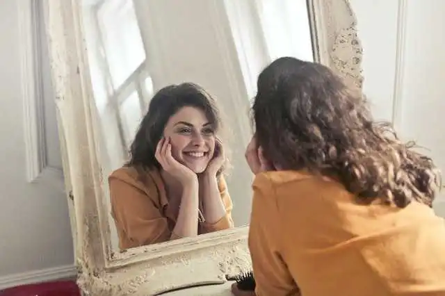 Close-up image of a person gently touching their face while avoiding squeezing a pimple. The visual emphasizes proper skincare habits and the importance of not picking or pressing pimples to prevent scarring and skin damage.